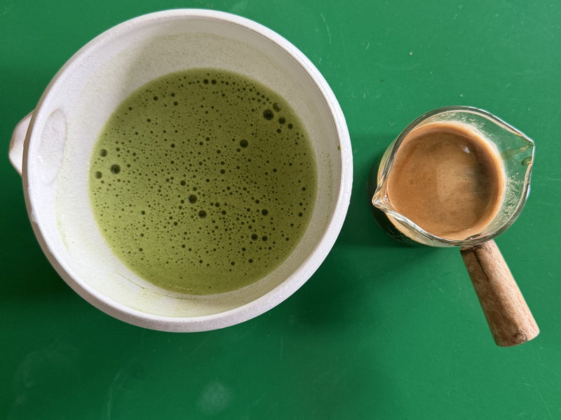 A bowl of usucha matcha next to an espresso at Morii Teahouse, Tallinn: about 64 mg versus 80 mg of caffeine