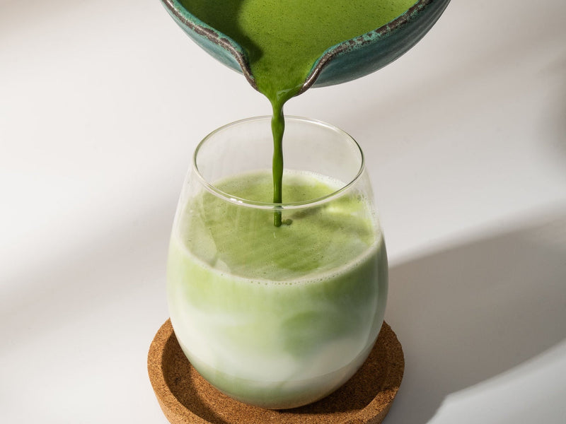 Whisked Morii matcha poured from a bowl into a glass of milk